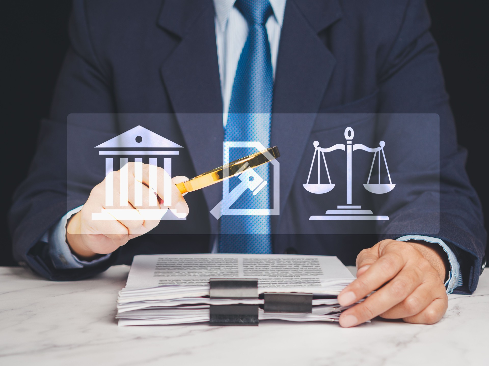 Lawyer in suit reviewing legal documents with justice icons overlay, concept of digital law firm.